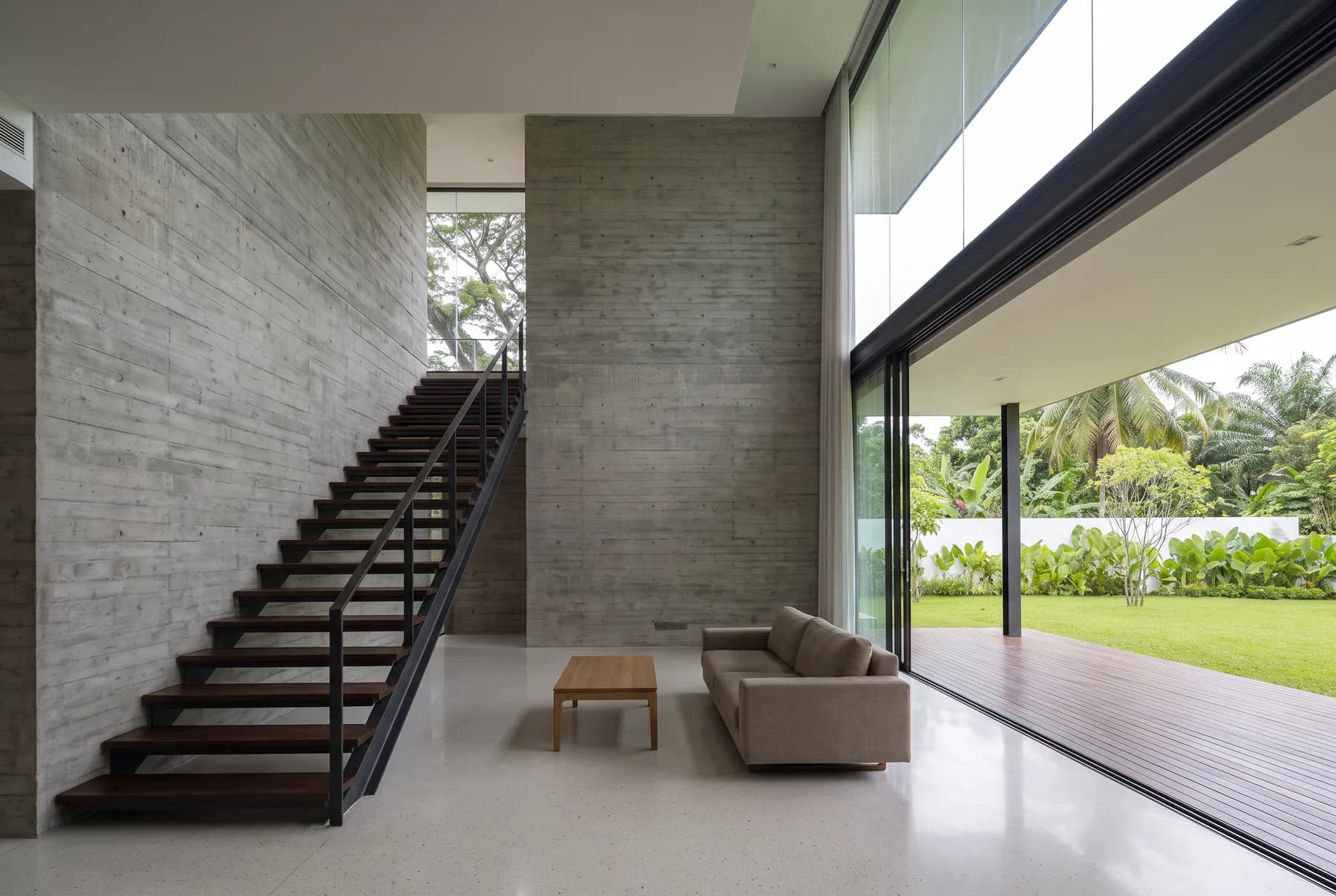 The double-height living space of a completed Beyond Constructions house, open to the garden